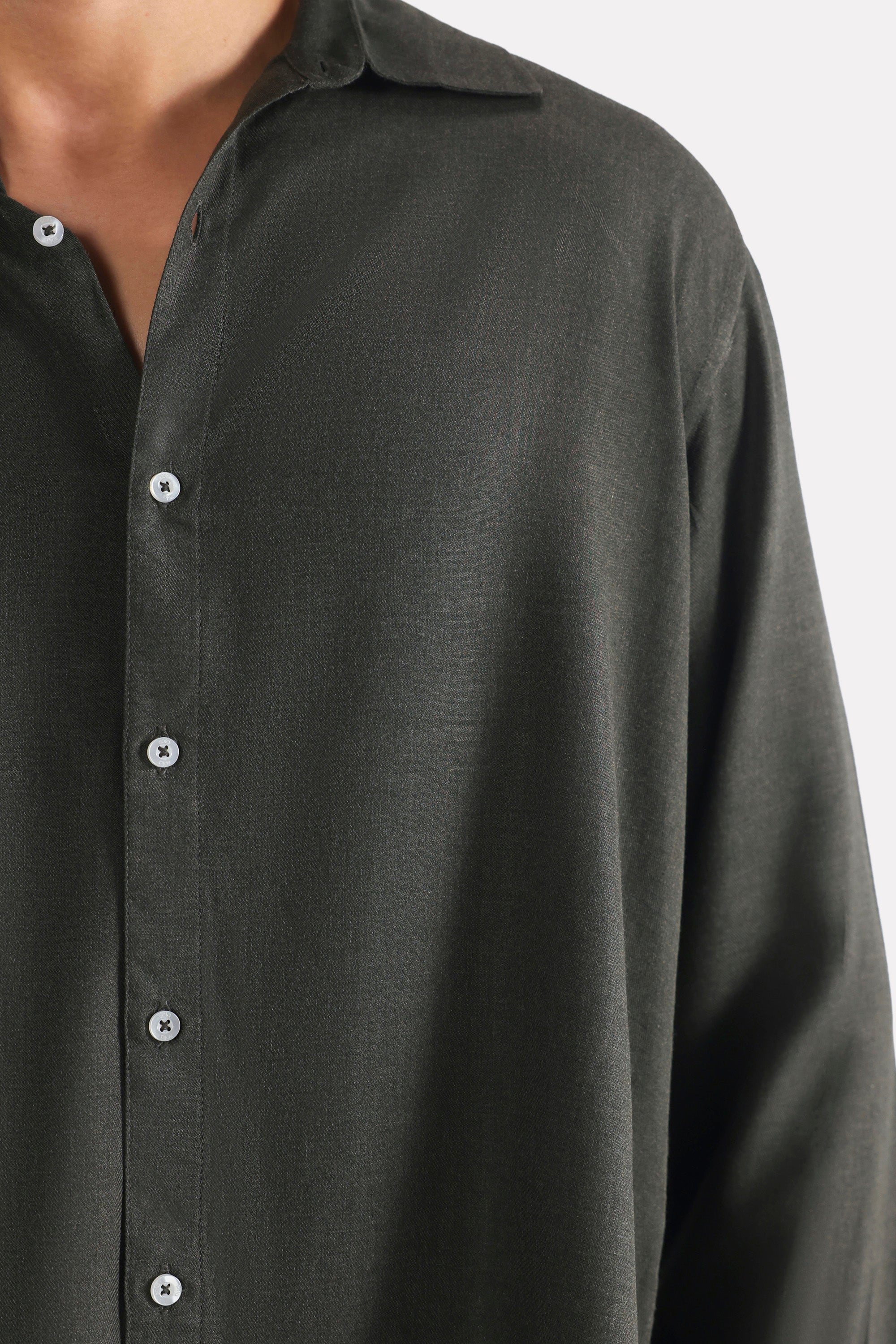 Close-up detail on the dark green (charcoal green) state flow button down shirt, by SOLA Pakistan.
