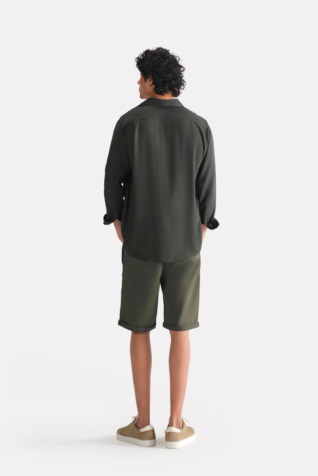 Flat lay of the dark green (charcoal green) state flow button down shirt, by SOLA Pakistan.