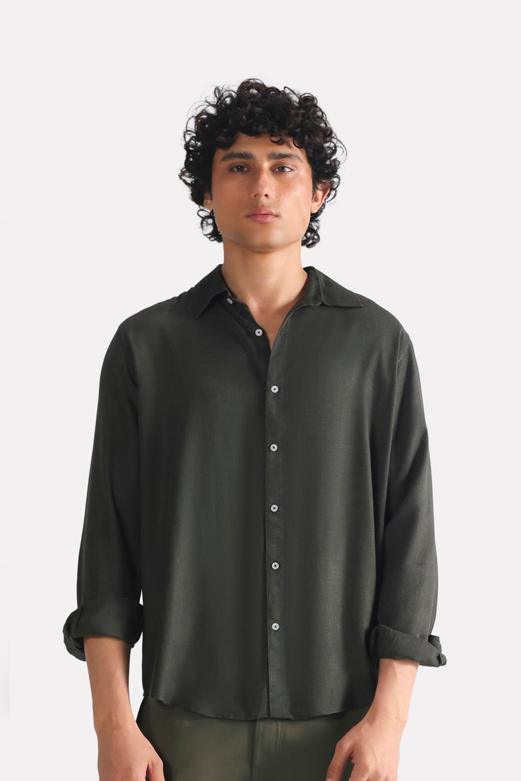 Dark green (charcoal green) state flow button down shirt in linen, worn by a model, by SOLA Pakistan.
