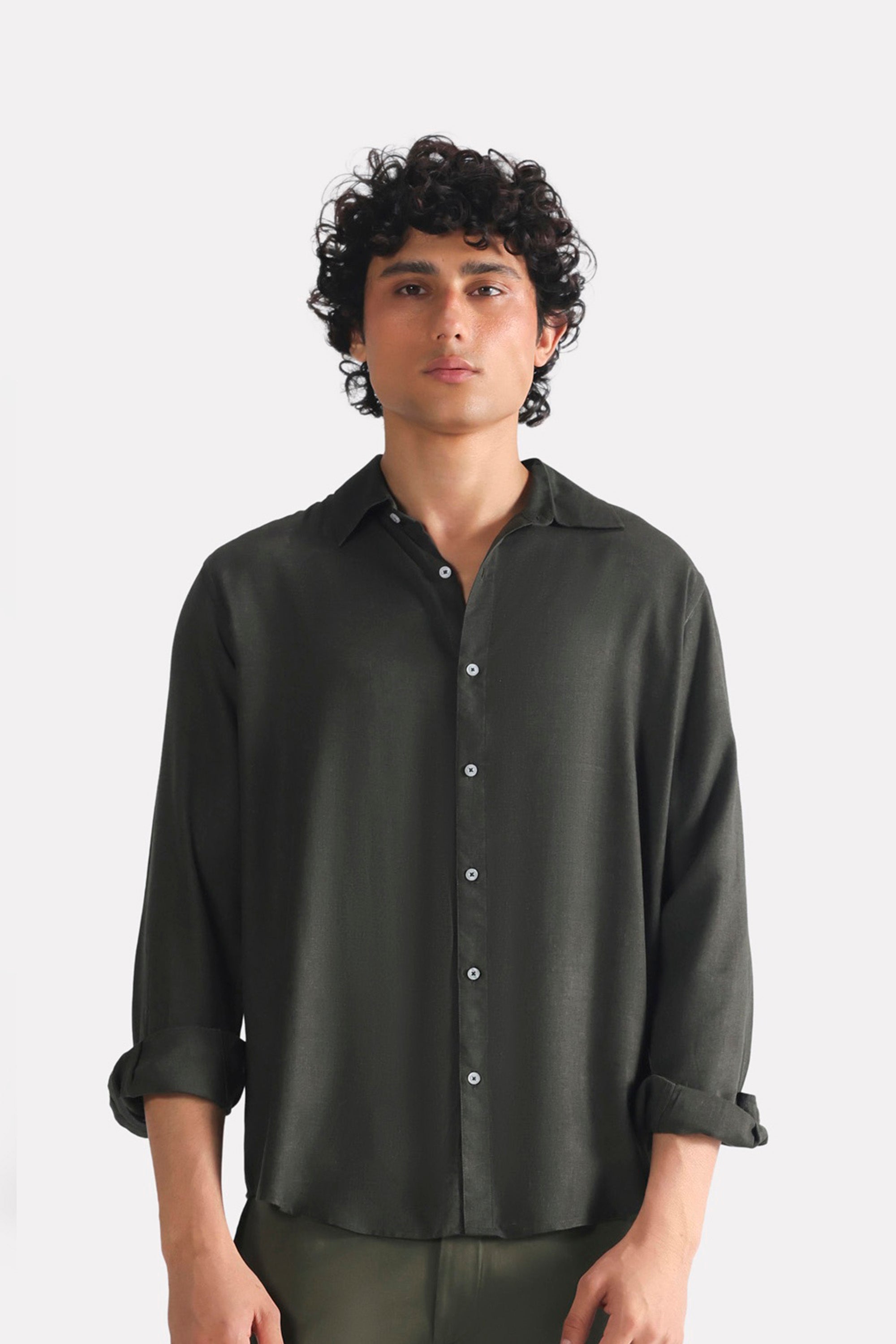 Dark green (charcoal green) state flow button down shirt in linen, worn by a model, by SOLA Pakistan.