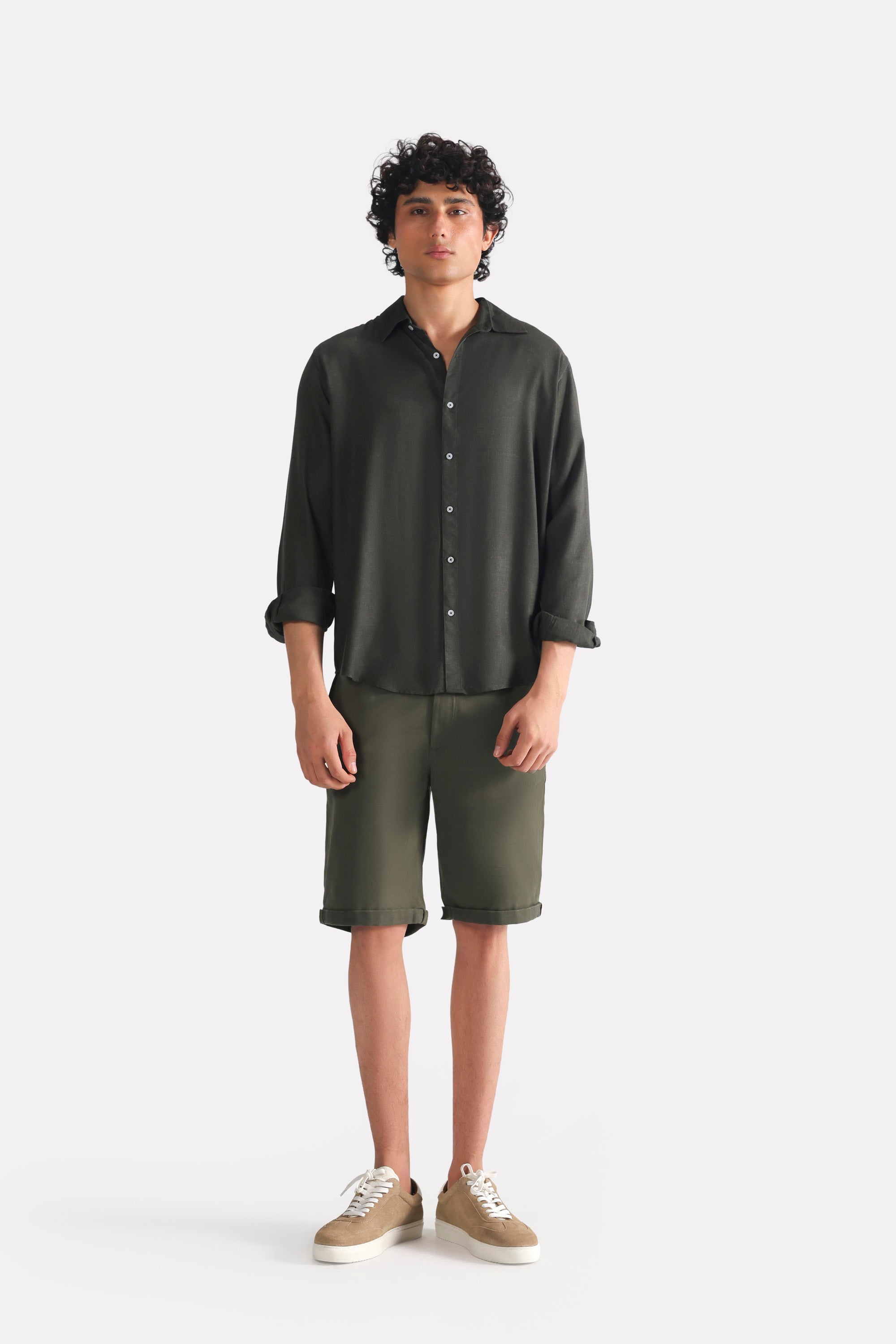 Dark green (charcoal green) state flow button down shirt shown in a styled fit, by SOLA Pakistan.