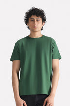 Dark green regular fit crew neck t-shirt in cotton, worn by a model, by SOLA Pakistan.
