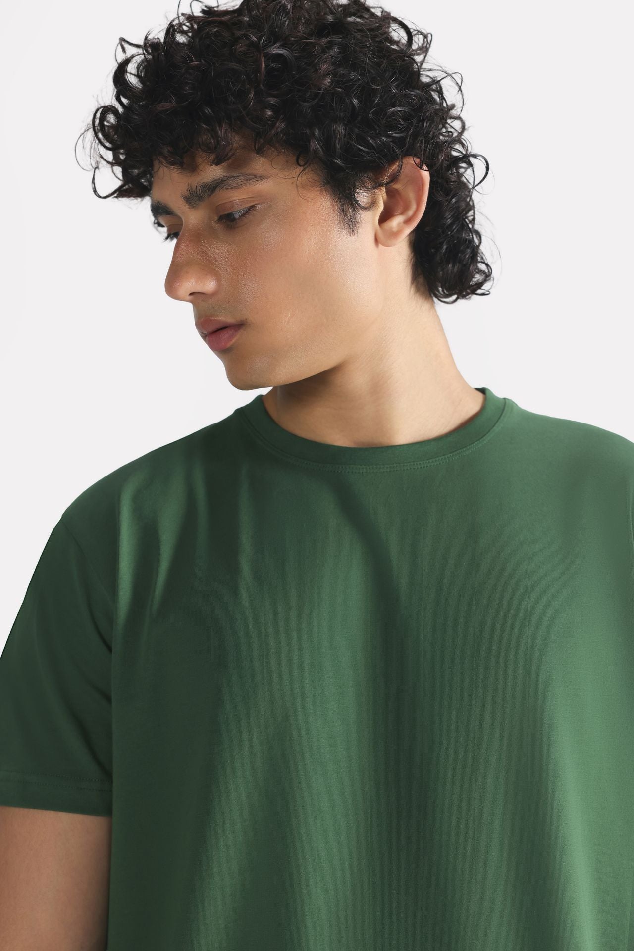 Dark green regular fit crew neck t-shirt shown in a styled fit, by SOLA Pakistan.
