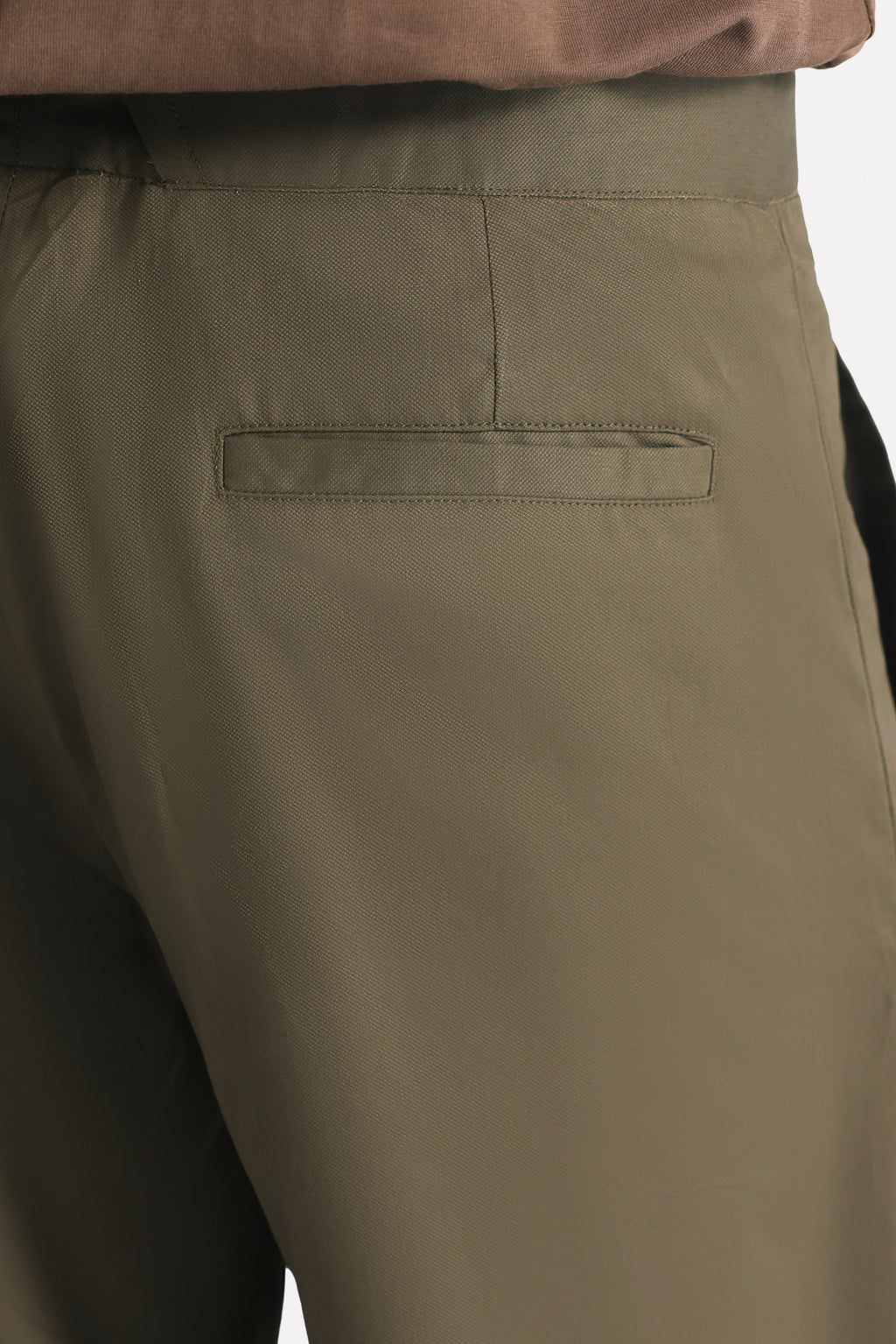Dark olive barrel-leg pleated trouser shown in a styled fit, by SOLA Pakistan.