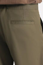 Dark olive barrel-leg pleated trouser shown in a styled fit, by SOLA Pakistan.