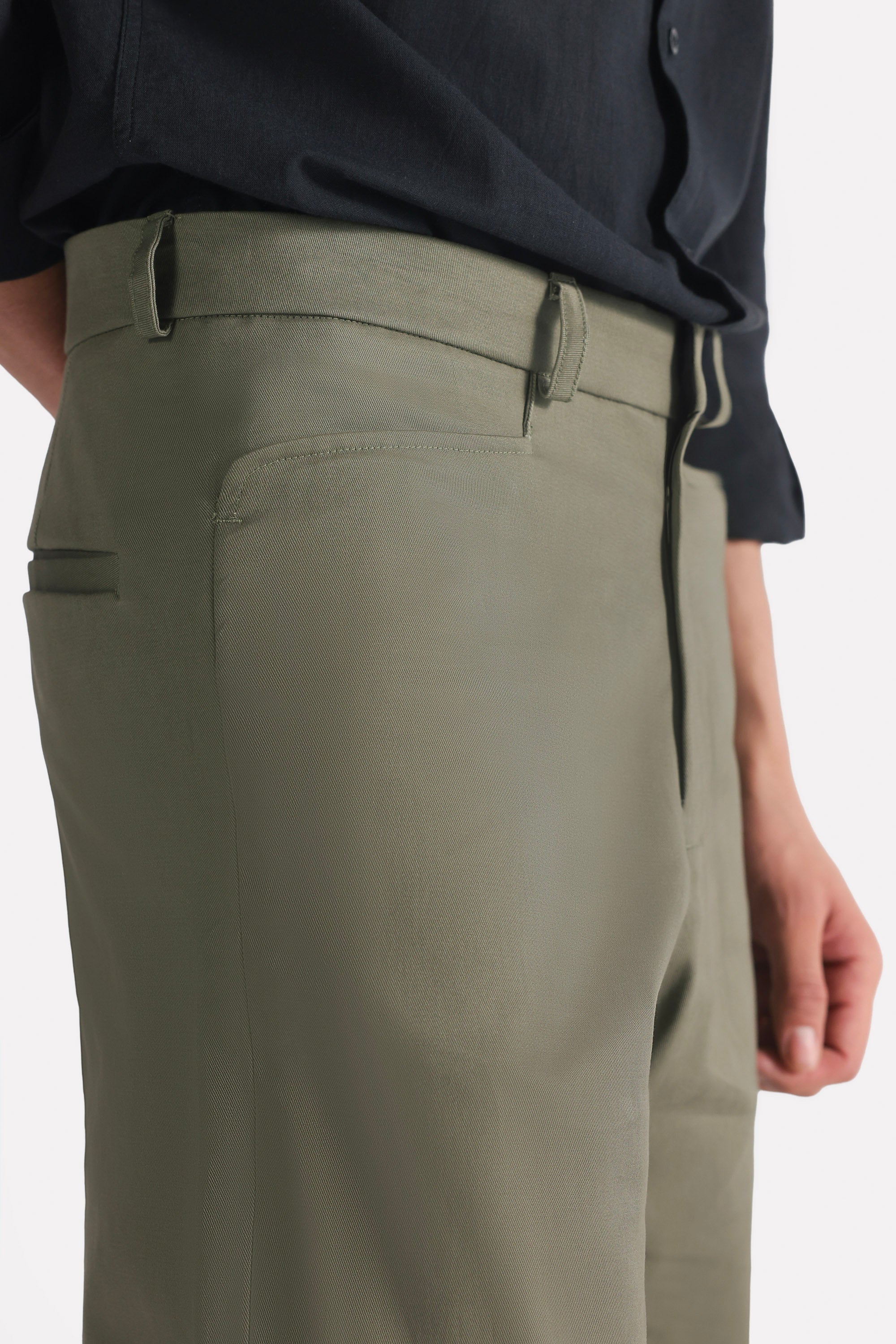 Close-up detail on the dark olive straight fit cotton trouser, by SOLA Pakistan.