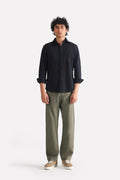 Dark olive straight fit cotton trouser, worn by a model, by SOLA Pakistan.