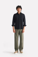 Dark olive straight fit cotton trouser, worn by a model, by SOLA Pakistan.