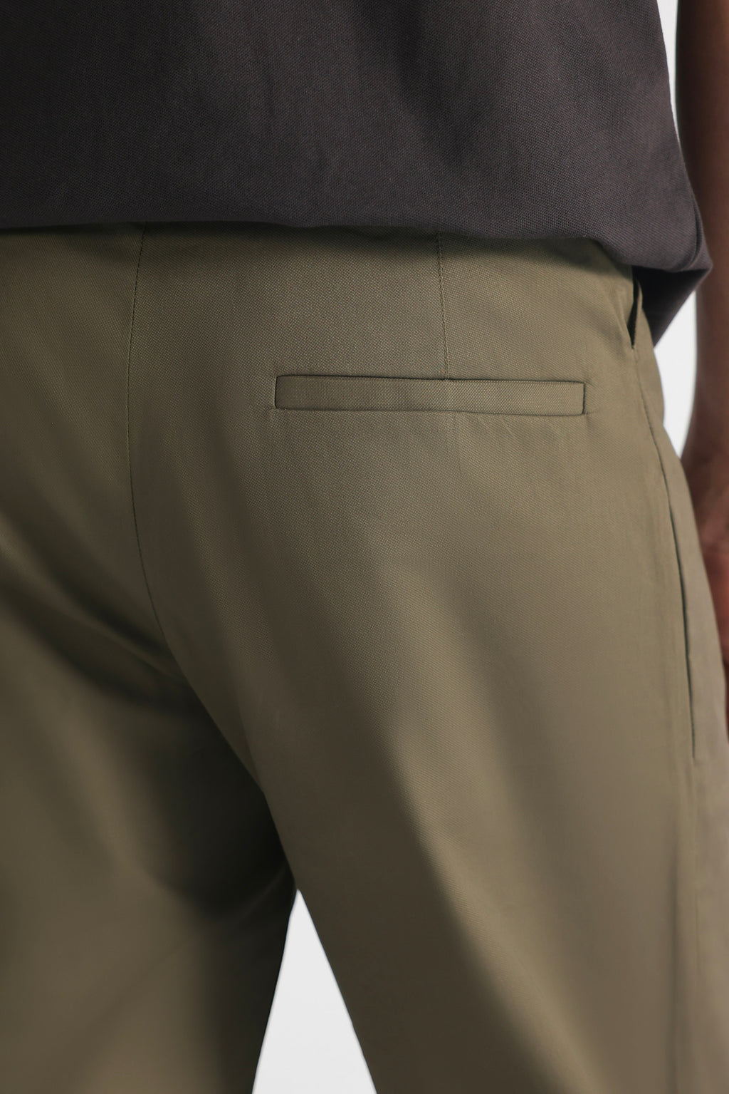 Close-up detail on the dark olive straight fit dobby trouser, by SOLA Pakistan.