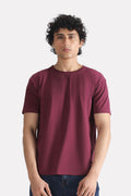 Dark red (burgundy) regular fit crew neck t-shirt in cotton, worn by a model, by SOLA Pakistan.