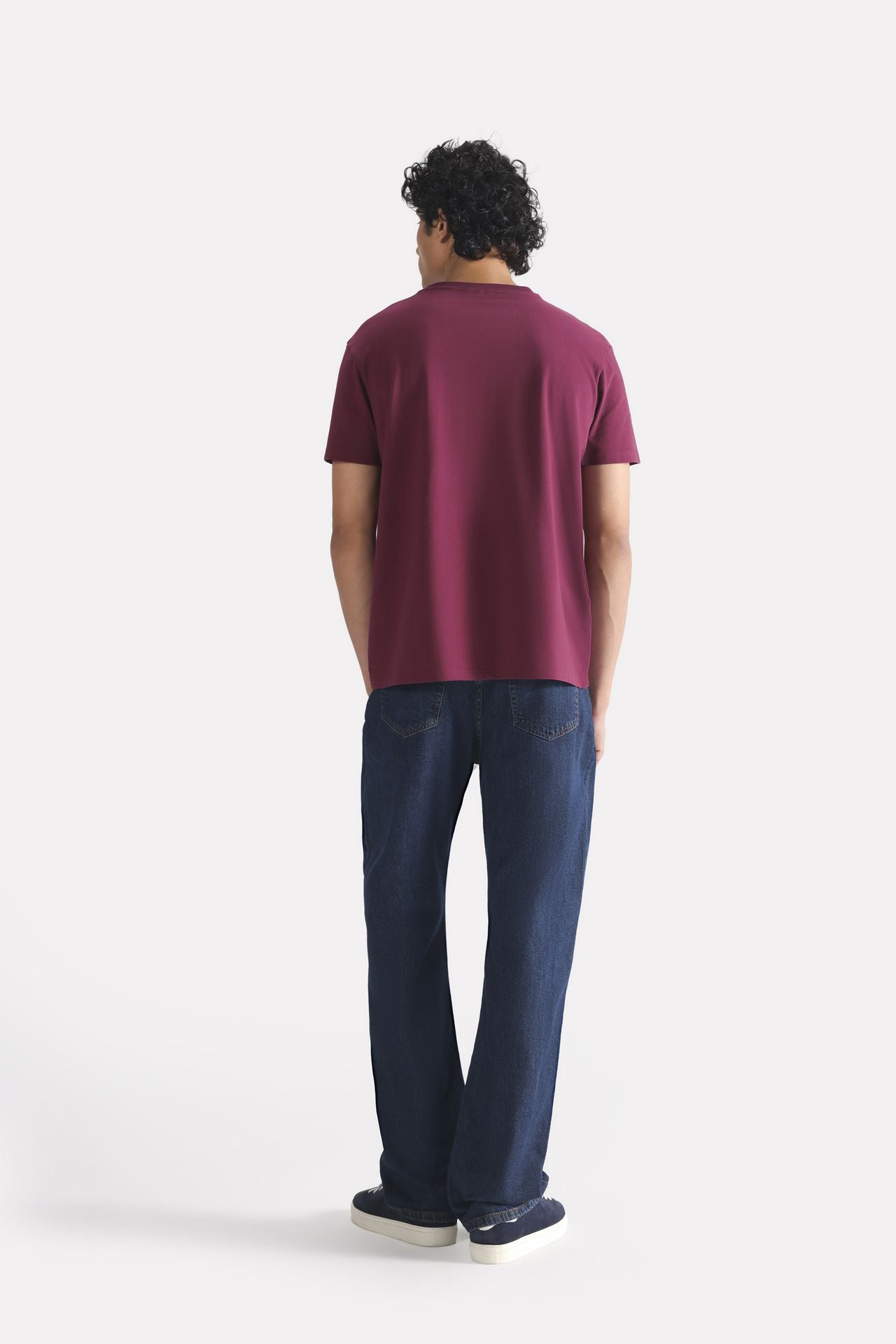 Dark red (burgundy) regular fit crew neck t-shirt shown in a styled fit, by SOLA Pakistan.