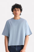 Faded blue (faded denim) drop shoulder cotton t-shirt, worn by a model, by SOLA Pakistan.