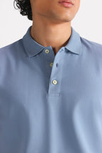 Close-up detail on the faded blue (faded denim) micro-textured cotton pique polo, by SOLA Pakistan.