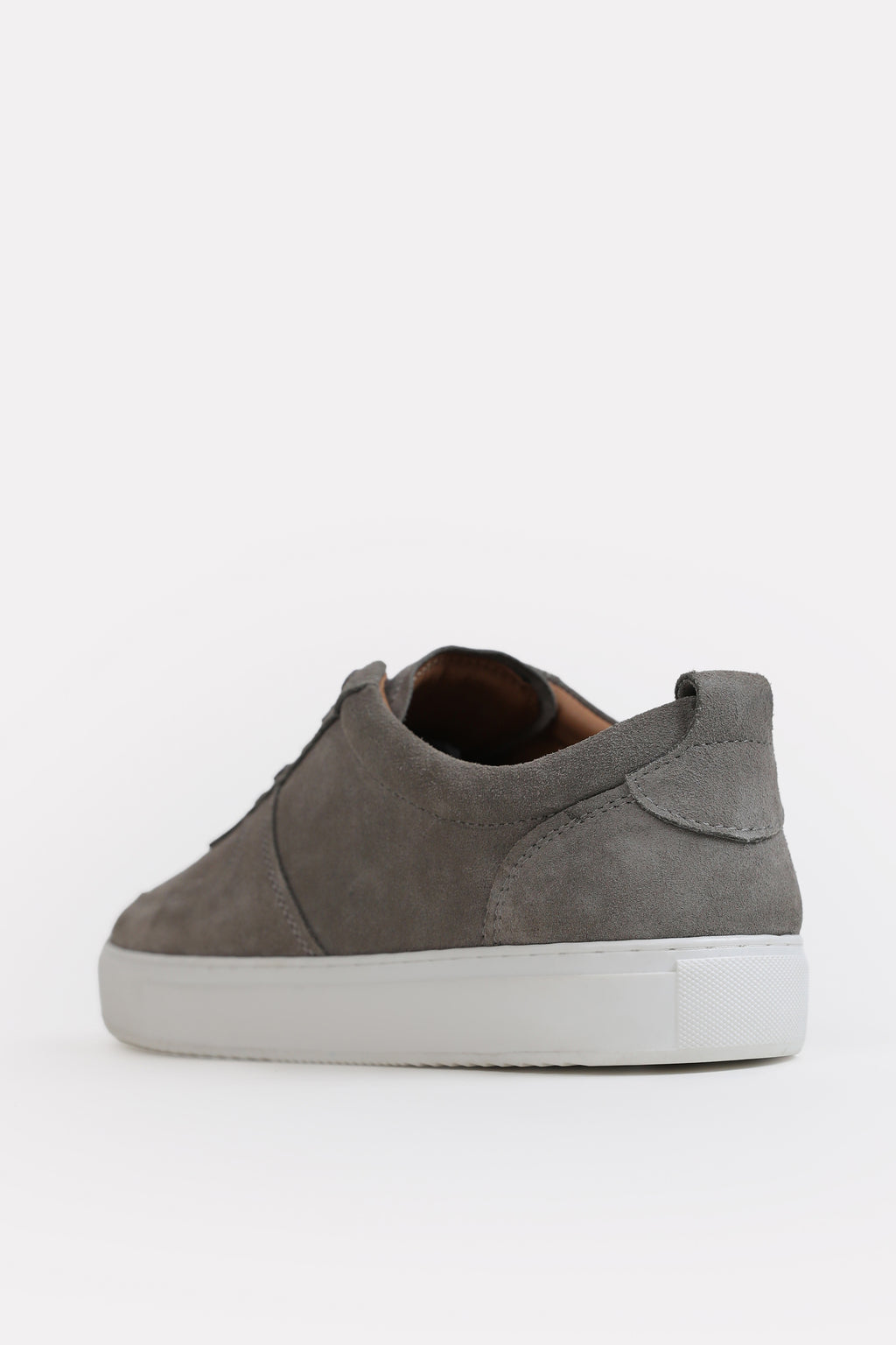 Flat lay of the grey essence suede trainer, by SOLA Pakistan.