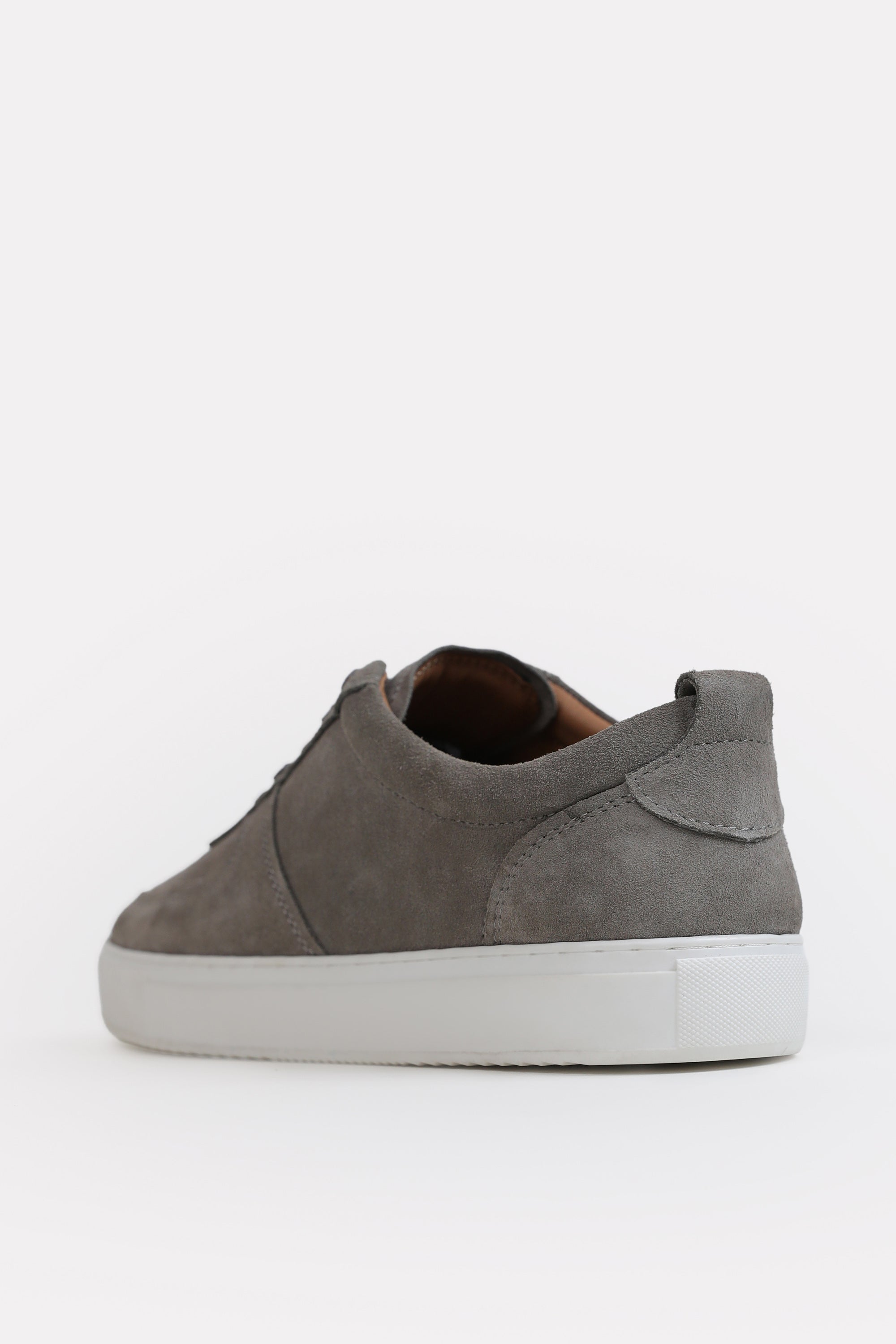 Flat lay of the grey essence suede trainer, by SOLA Pakistan.