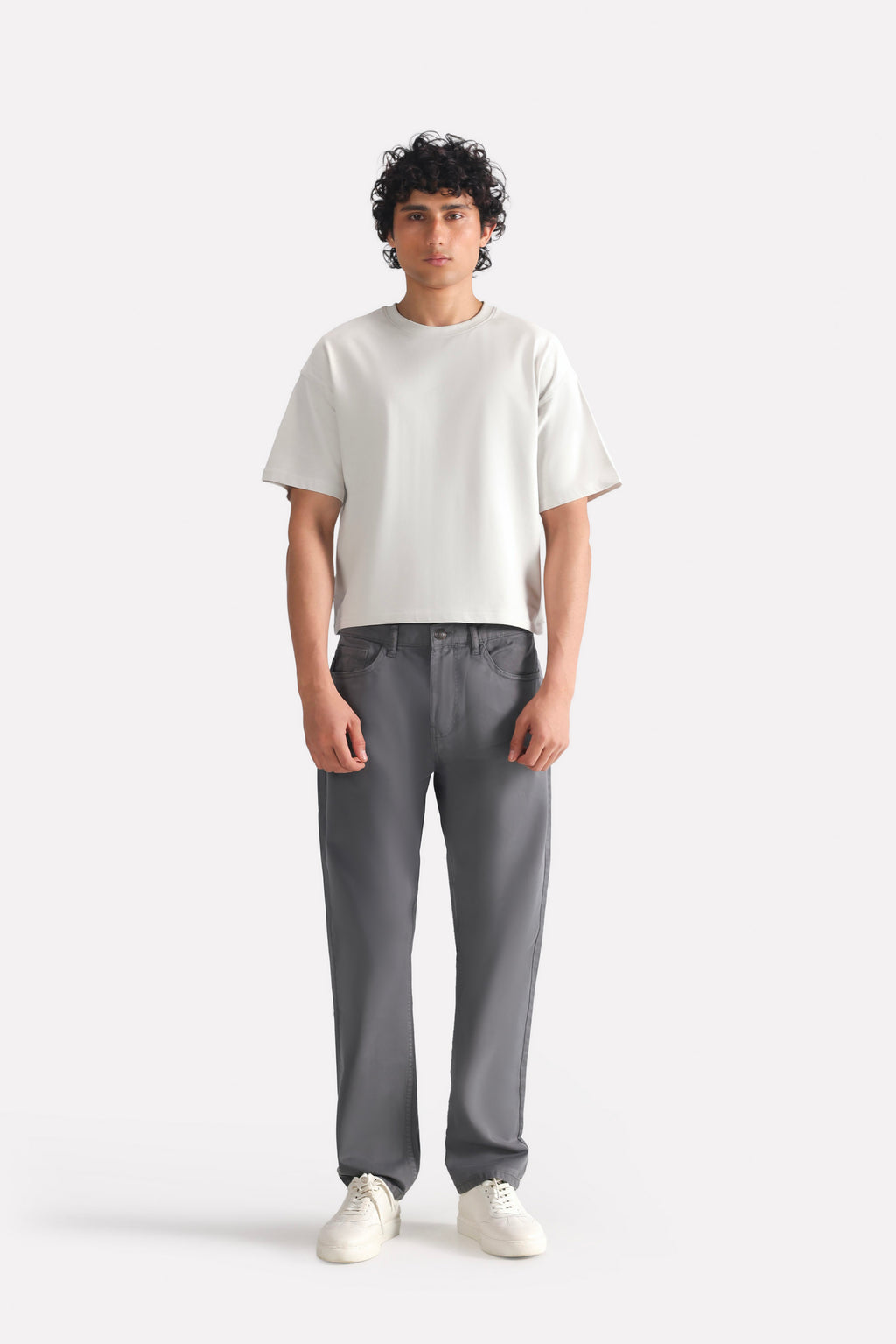 Grey garment-dyed casual trouser in cotton, worn by a model, by SOLA Pakistan.