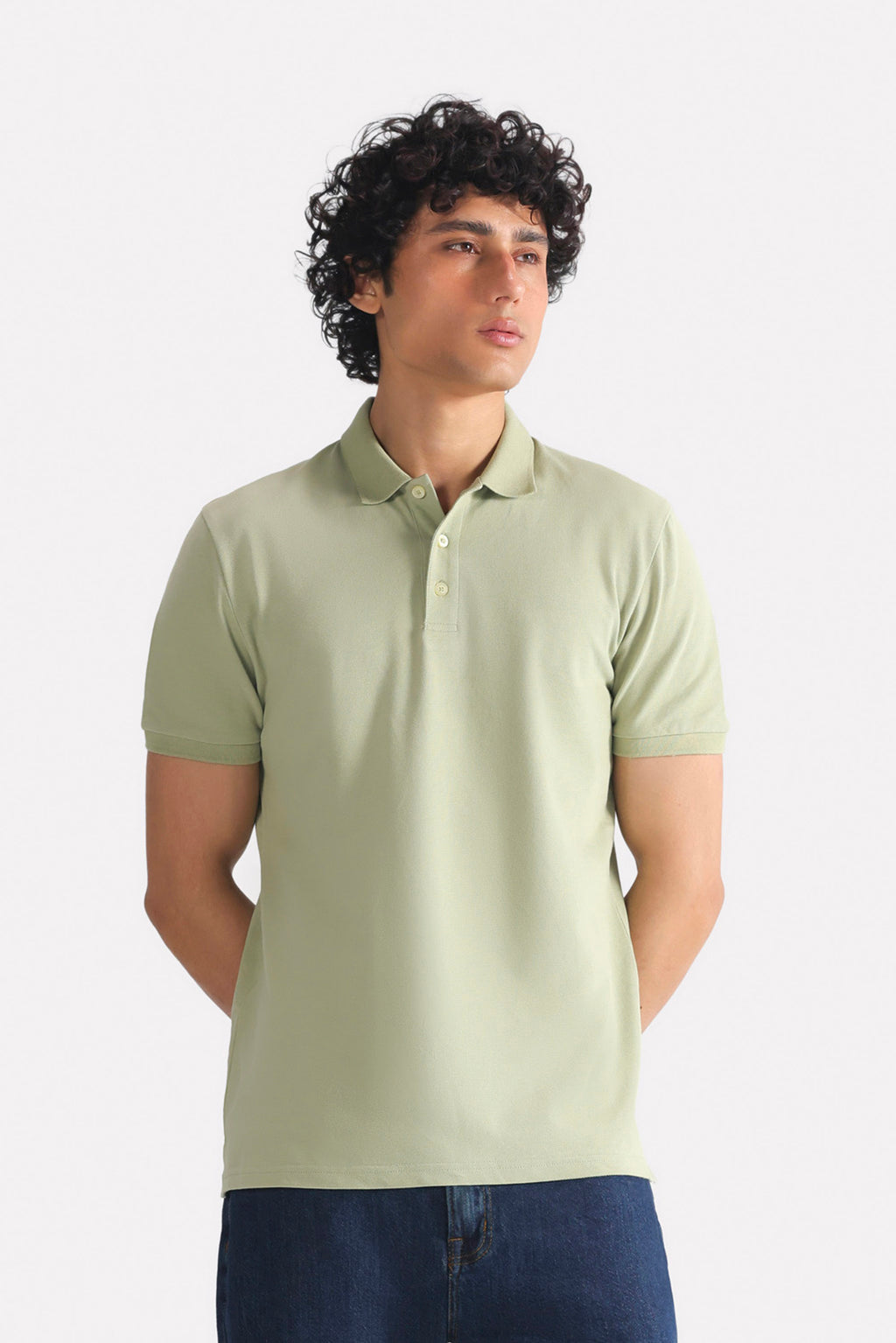 Khaki beige (faded khaki) micro-textured cotton pique polo, worn by a model, by SOLA Pakistan.