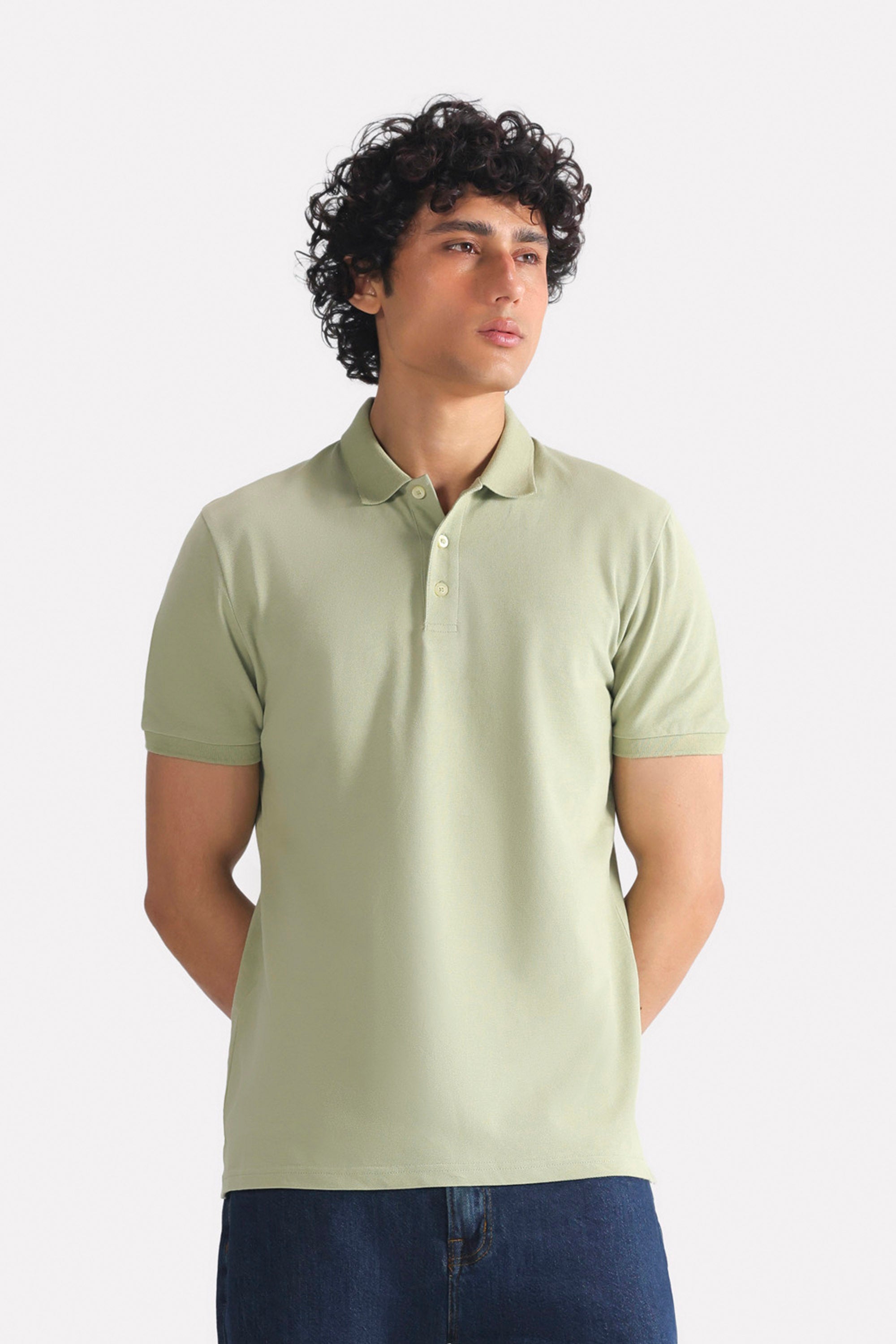 Khaki beige (faded khaki) micro-textured cotton pique polo, worn by a model, by SOLA Pakistan.