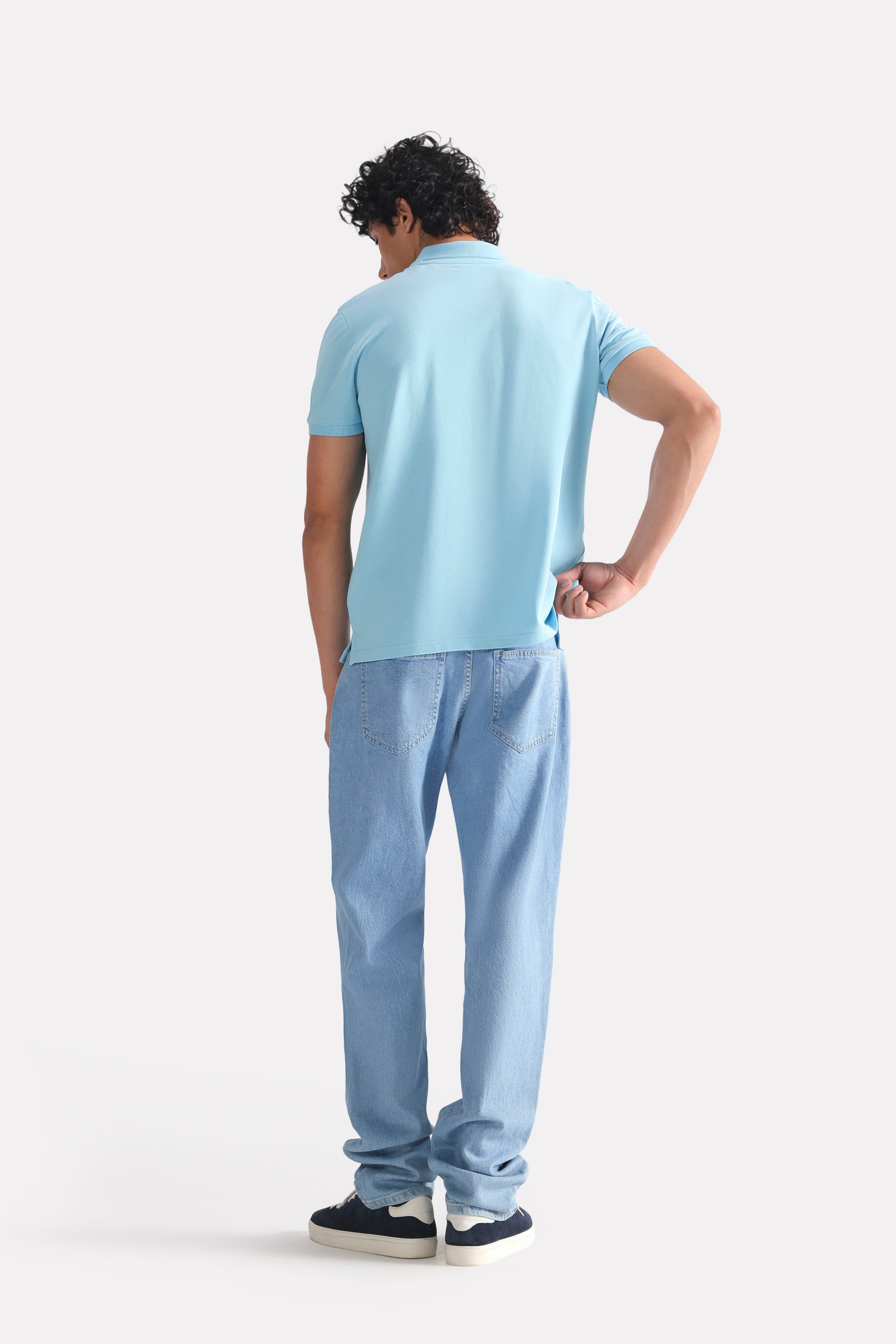 Flat lay of the light blue micro-textured cotton pique polo, by SOLA Pakistan.