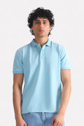 Light blue micro-textured cotton pique polo, worn by a model, by SOLA Pakistan.