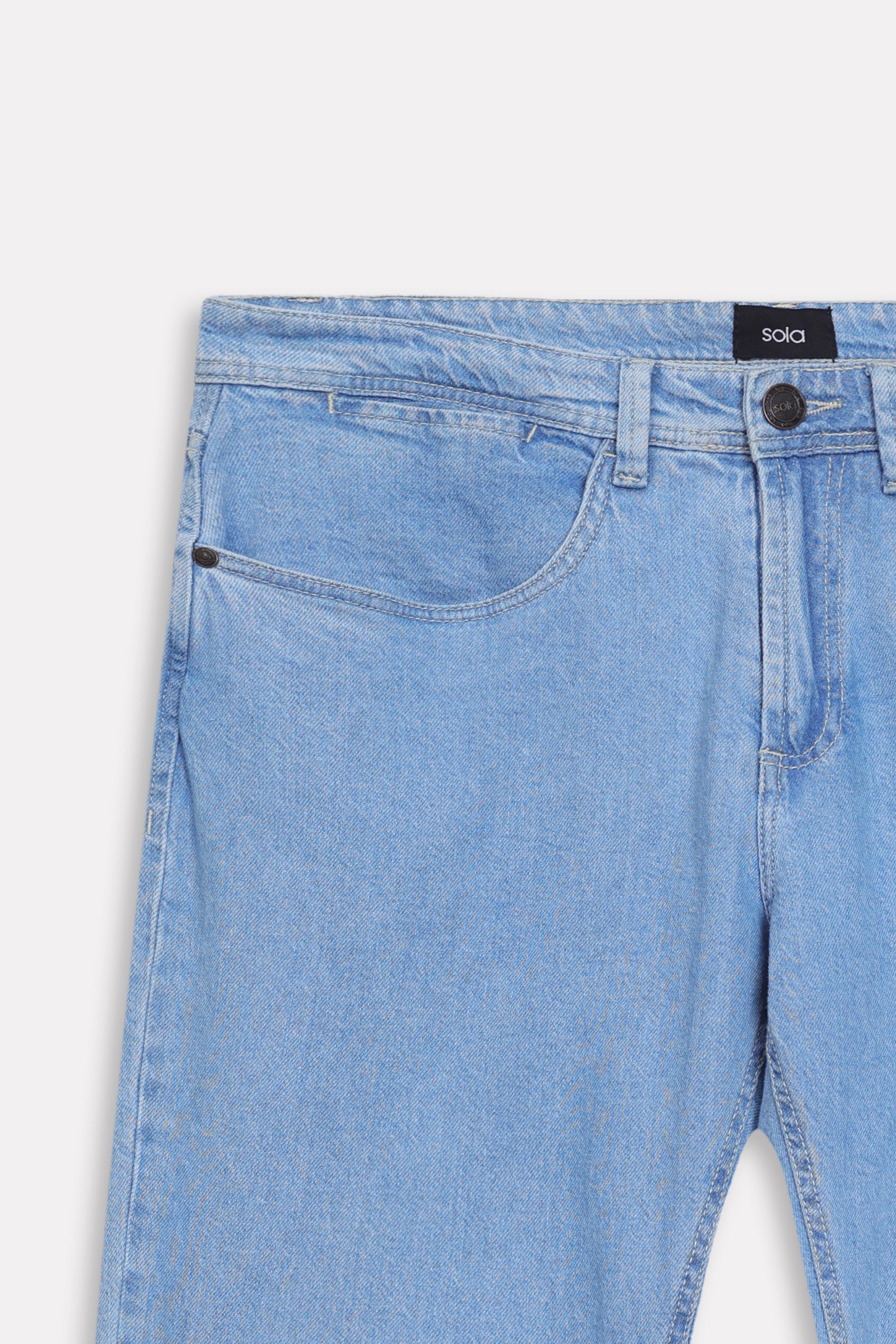 Texture and fabric detail, light blue signature regular fit jeans, by SOLA Pakistan.