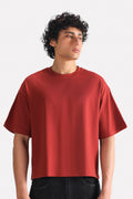 Matt red drop shoulder cotton t-shirt, worn by a model, by SOLA Pakistan.