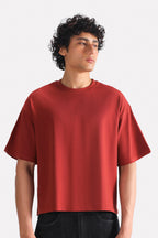 Matt red drop shoulder cotton t-shirt, worn by a model, by SOLA Pakistan.