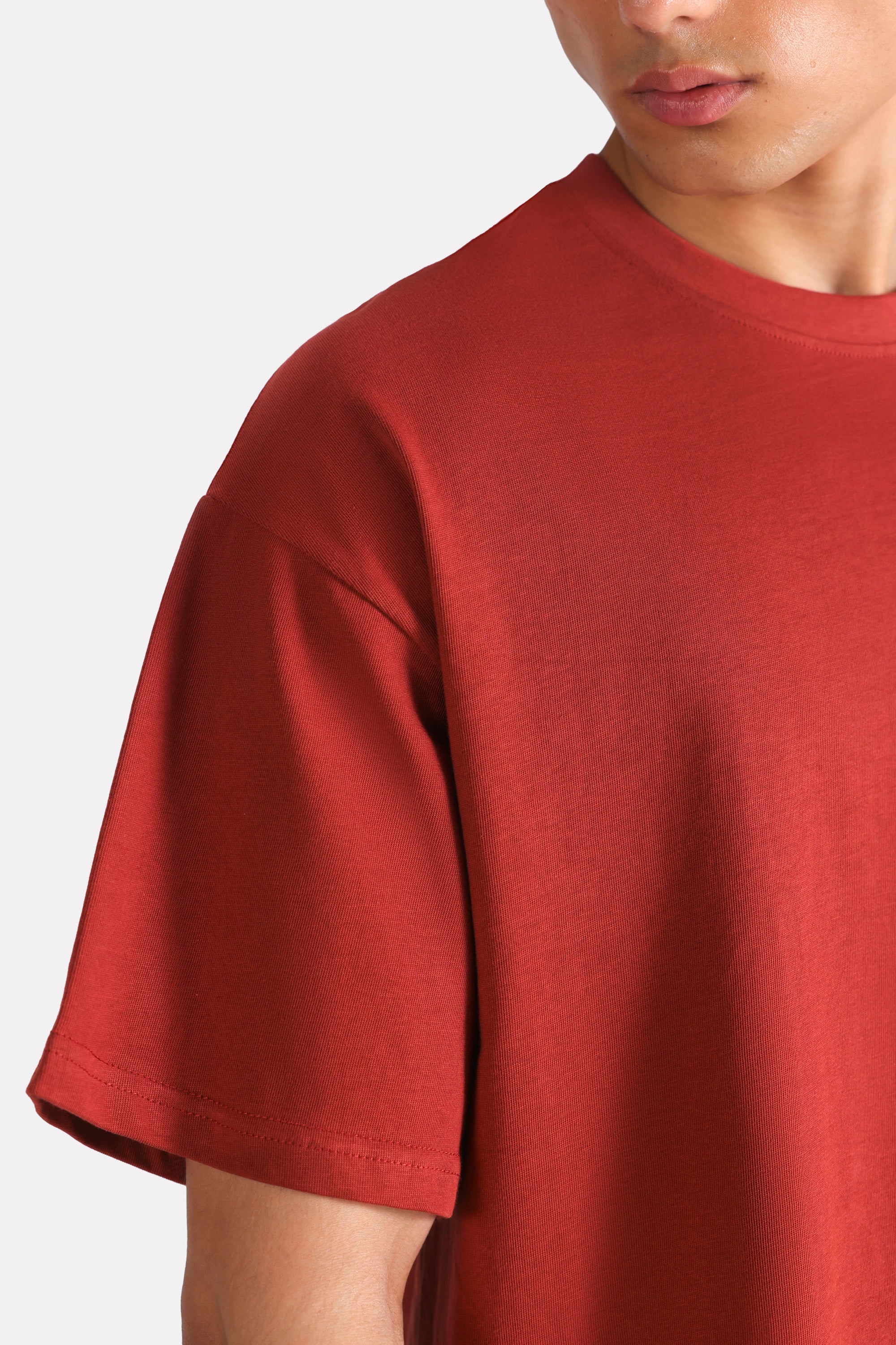 Matt red drop shoulder cotton t-shirt shown in a styled fit, by SOLA Pakistan.