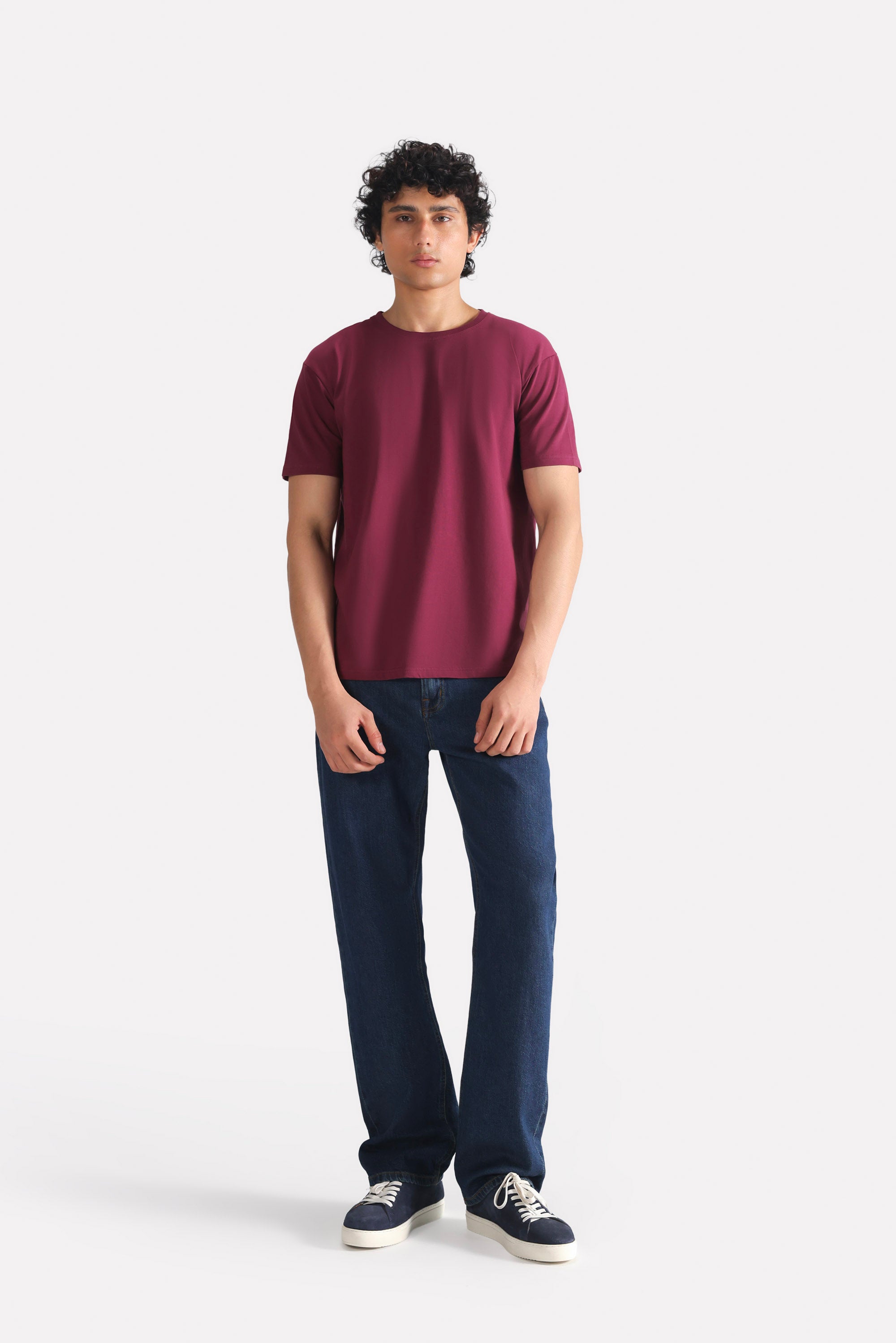 Mid blue signature regular fit jeans in cotton, worn by a model, by SOLA Pakistan.
