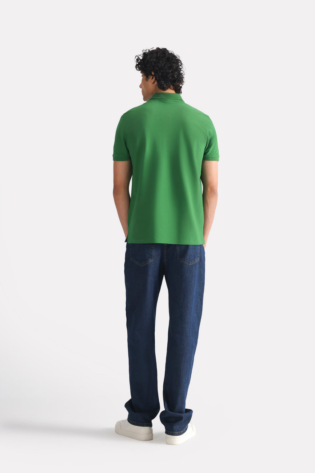 Flat lay of the moss green micro-textured cotton pique polo, by SOLA Pakistan.