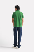 Flat lay of the moss green micro-textured cotton pique polo, by SOLA Pakistan.