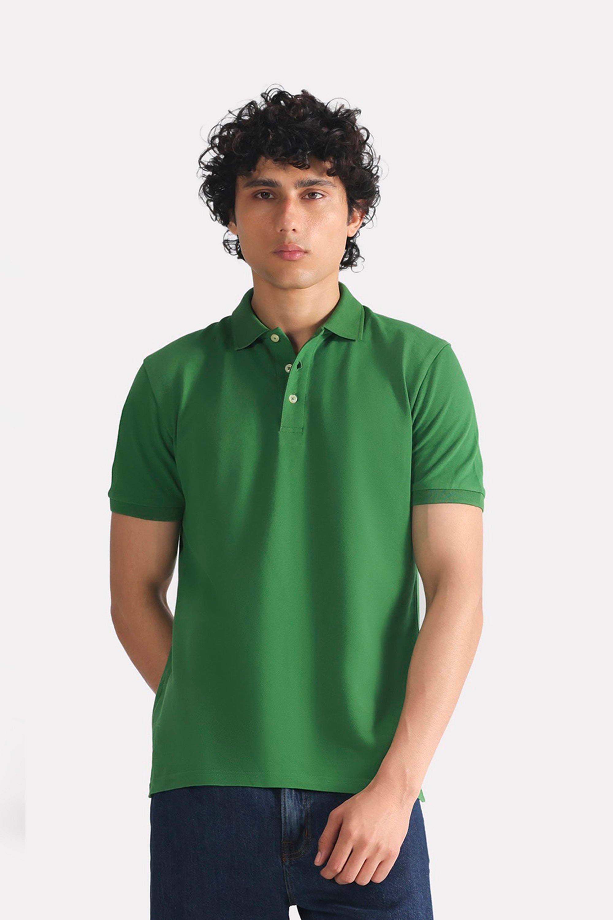 Moss green micro-textured cotton pique polo, worn by a model, by SOLA Pakistan.
