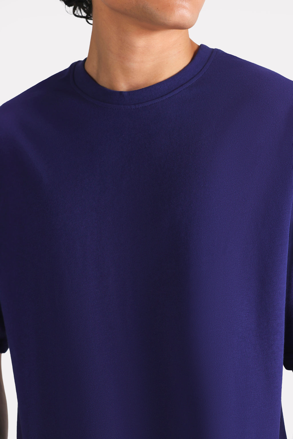 Close-up detail on the navy drop shoulder cotton t-shirt, by SOLA Pakistan.