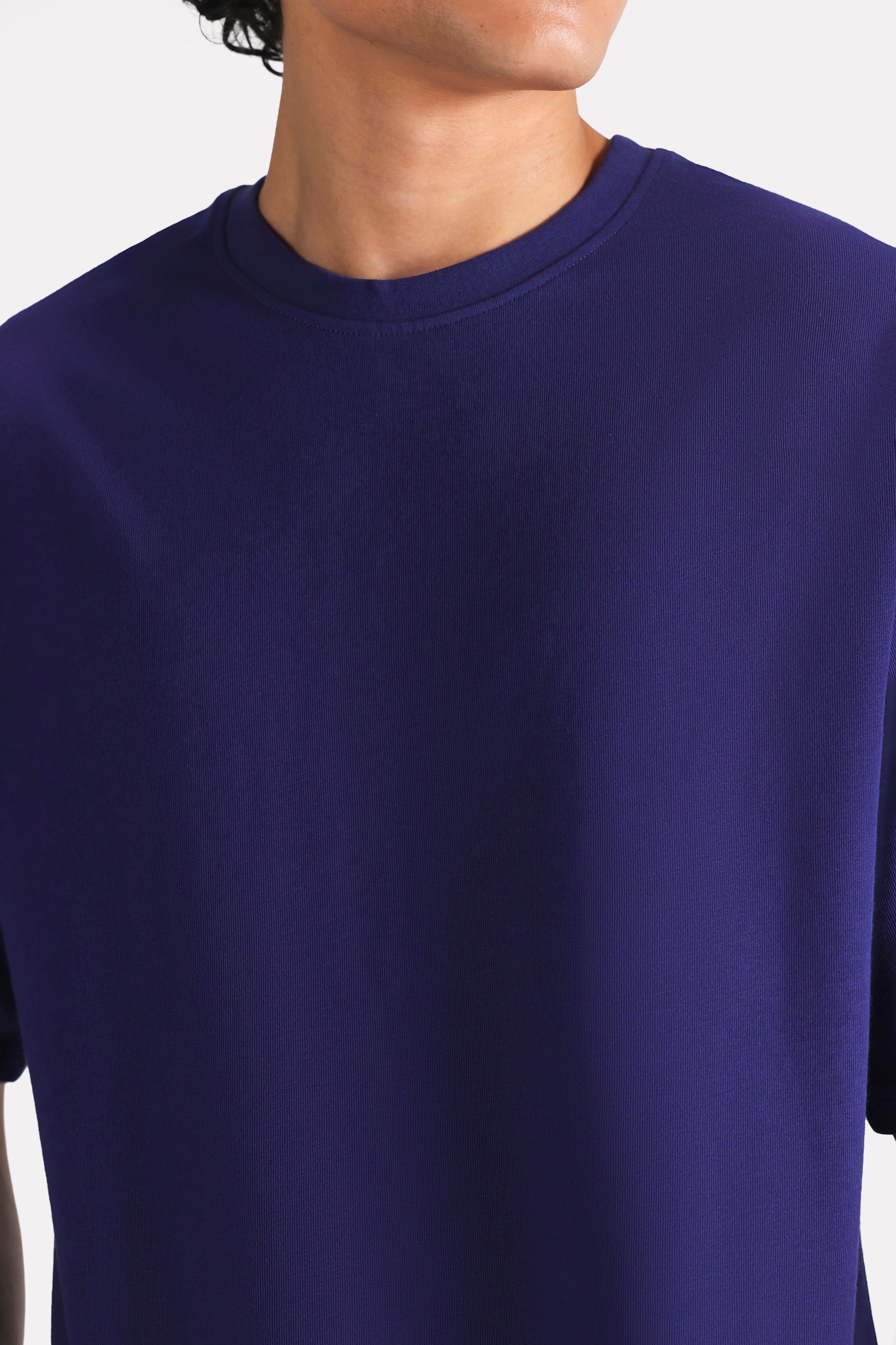 Close-up detail on the navy drop shoulder cotton t-shirt, by SOLA Pakistan.