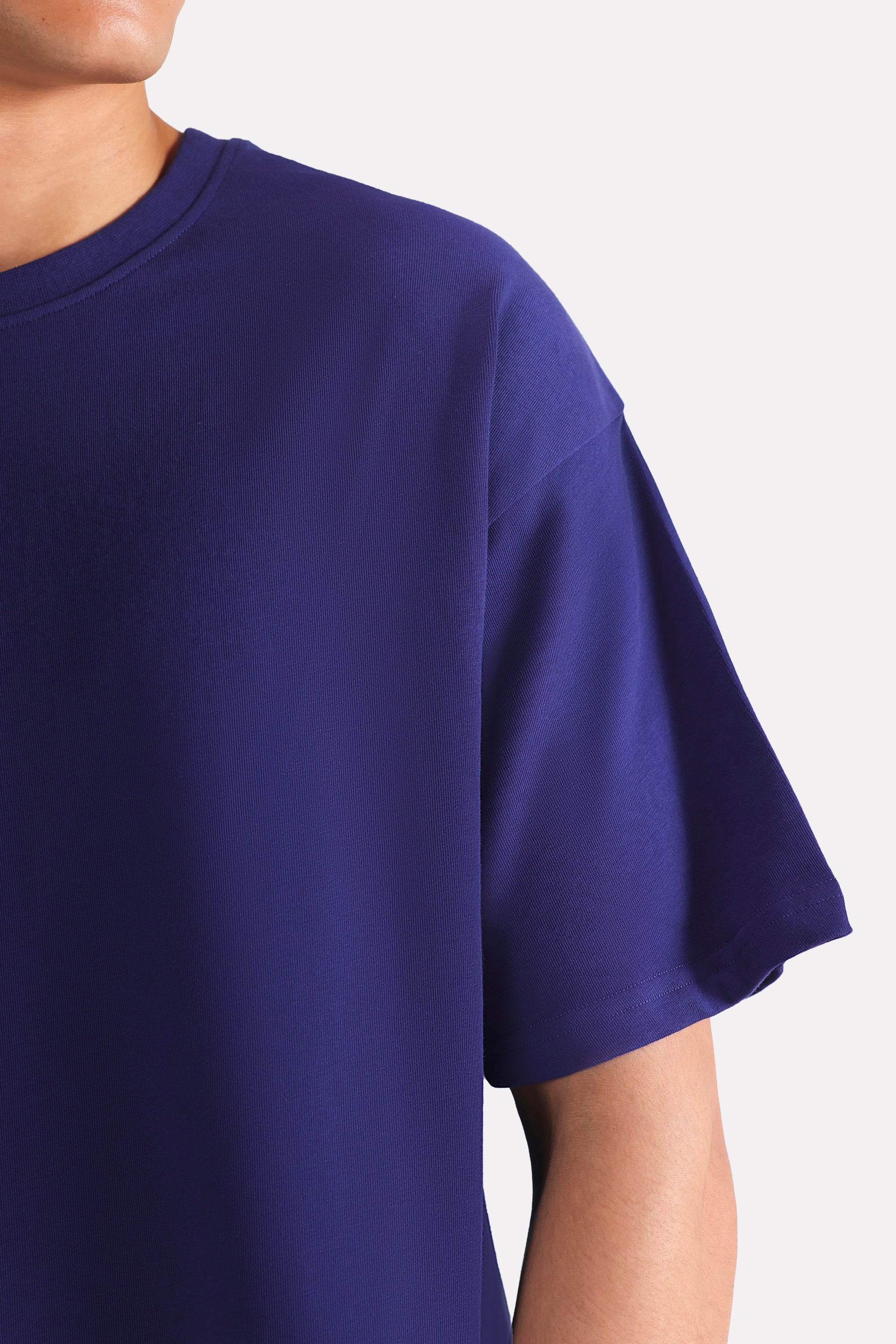 Flat lay of the navy drop shoulder cotton t-shirt, by SOLA Pakistan.