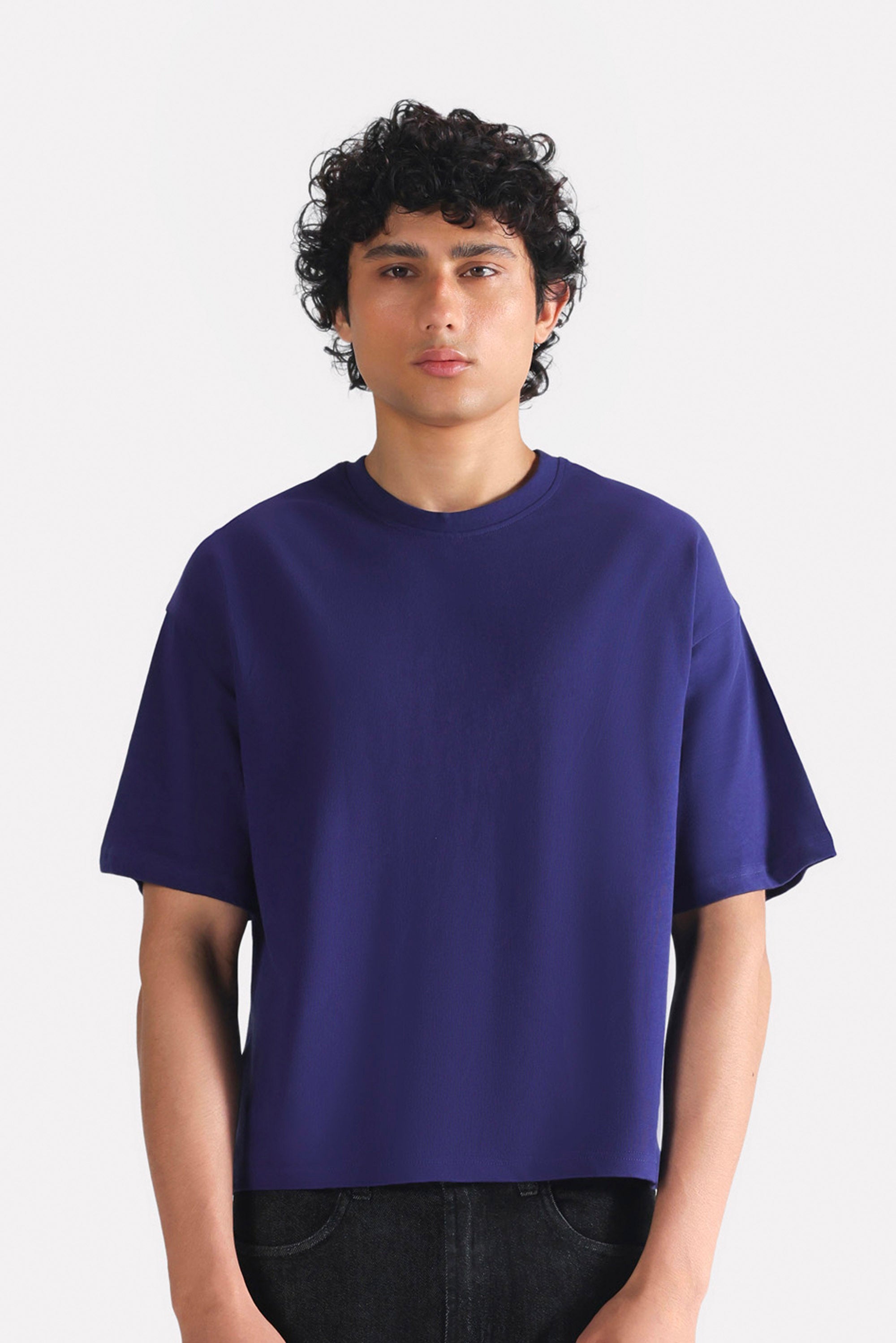Navy drop shoulder cotton t-shirt, worn by a model, by SOLA Pakistan.