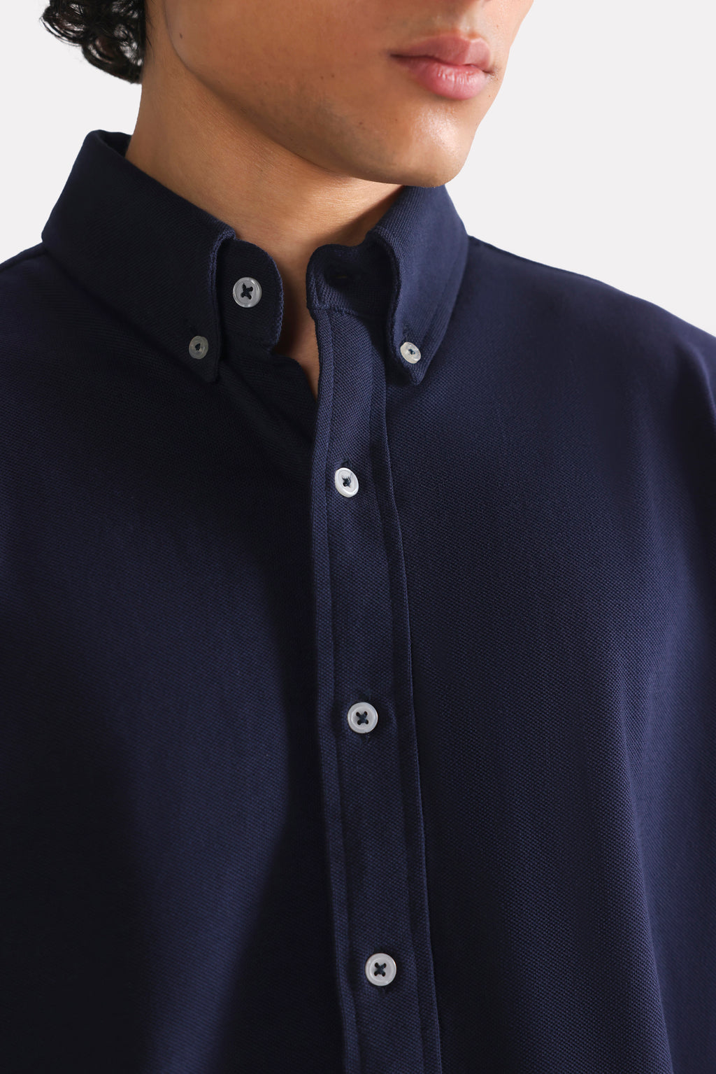 Close-up detail on the navy regular fit pique shirt, by SOLA Pakistan.