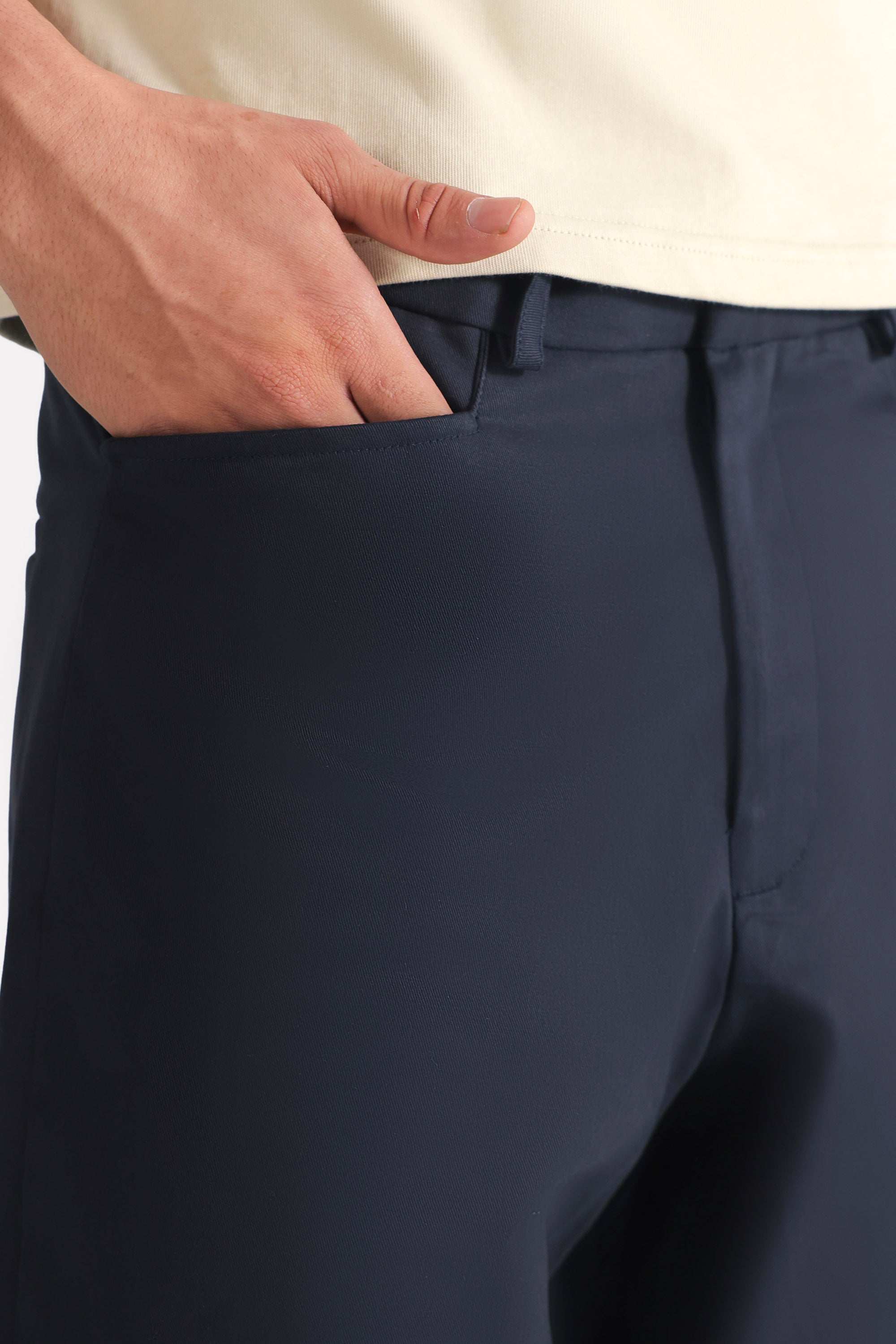 Close-up detail on the navy straight fit cotton trouser, by SOLA Pakistan.