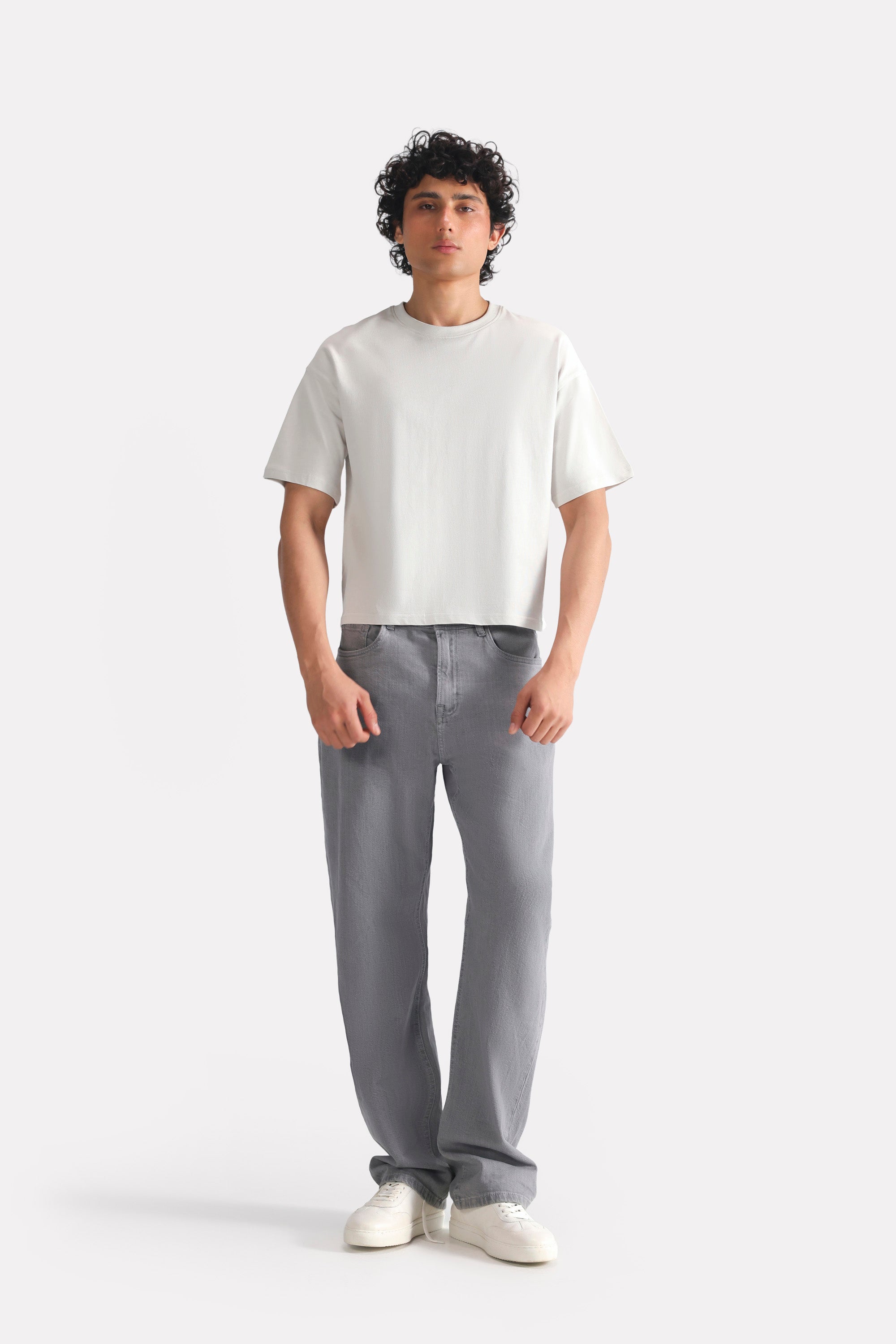 Close-up detail on the off-white (cloud dancer) drop shoulder cotton t-shirt, by SOLA Pakistan.