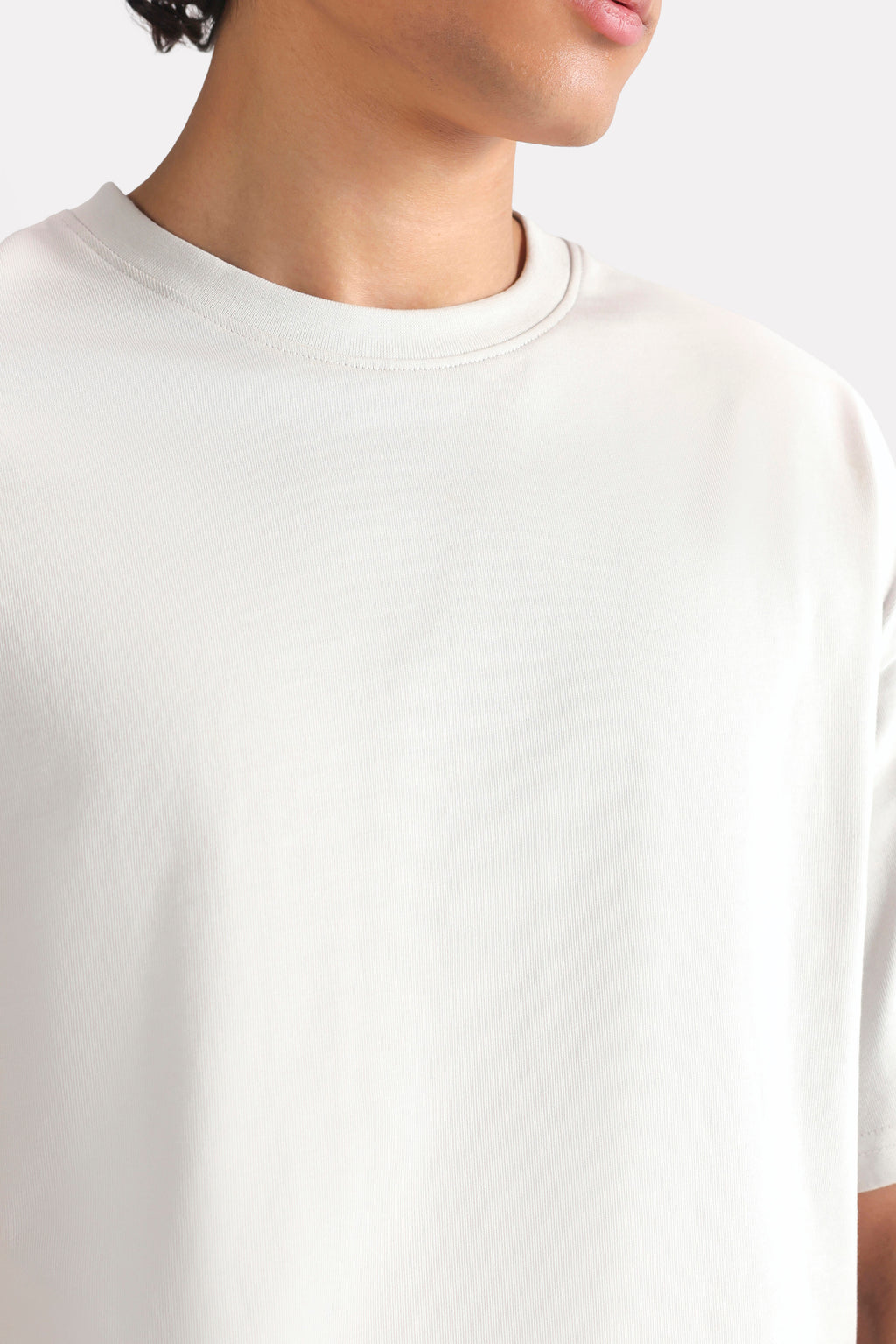 Flat lay of the off-white (cloud dancer) drop shoulder cotton t-shirt, by SOLA Pakistan.