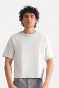 Off-white (cloud dancer) drop shoulder cotton t-shirt, worn by a model, by SOLA Pakistan.