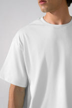 Close-up detail on the off-white (cloud dancer) heavy weight cropped t-shirt, by SOLA Pakistan.