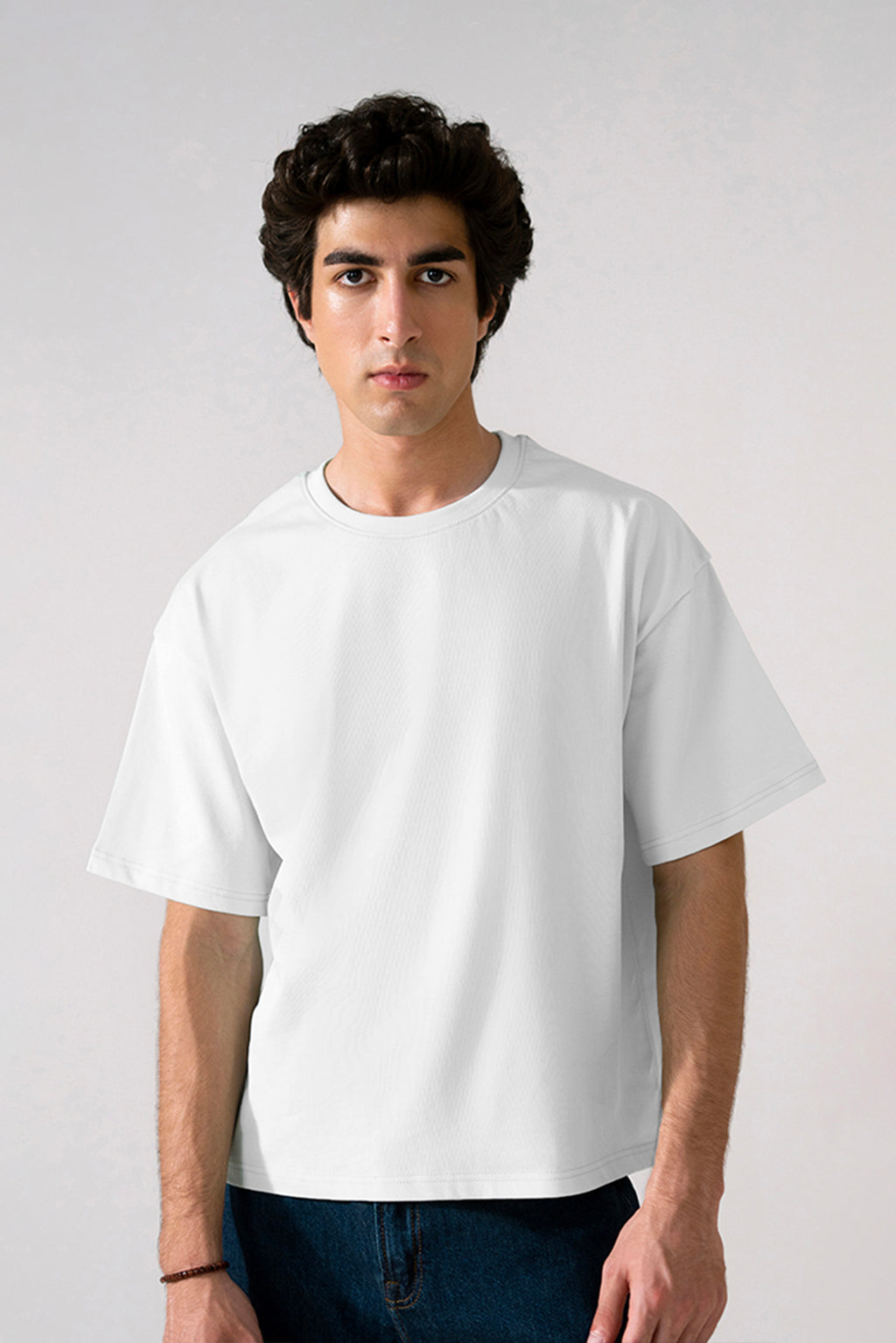 Off-white (cloud dancer) heavy weight cropped t-shirt in cotton, worn by a model, by SOLA Pakistan.