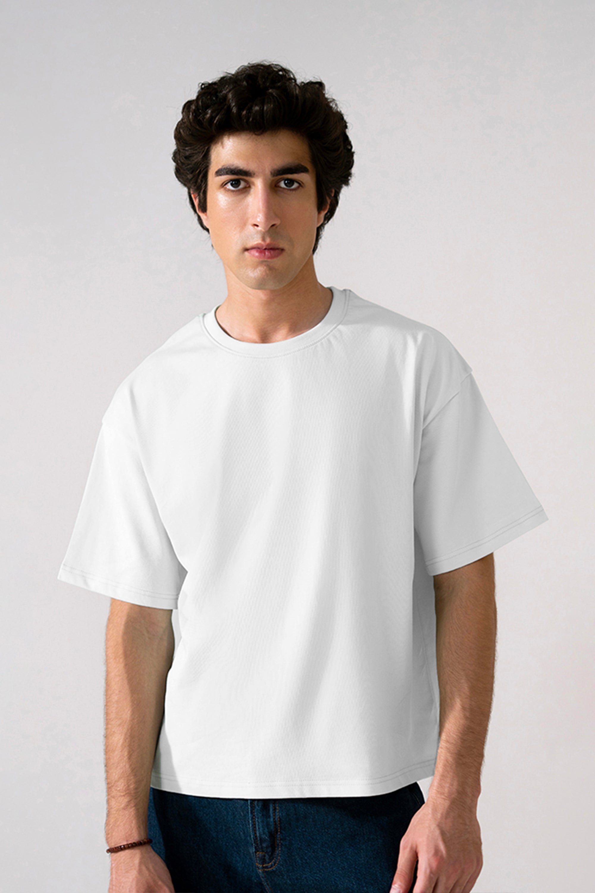 Off-white (cloud dancer) heavy weight cropped t-shirt in cotton, worn by a model, by SOLA Pakistan.