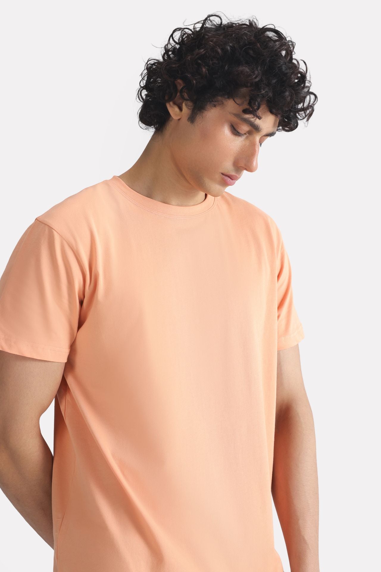 Close-up detail on the peach (apricot) regular fit crew neck t-shirt, by SOLA Pakistan.