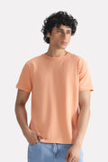 Peach (apricot) regular fit crew neck t-shirt in cotton, worn by a model, by SOLA Pakistan.