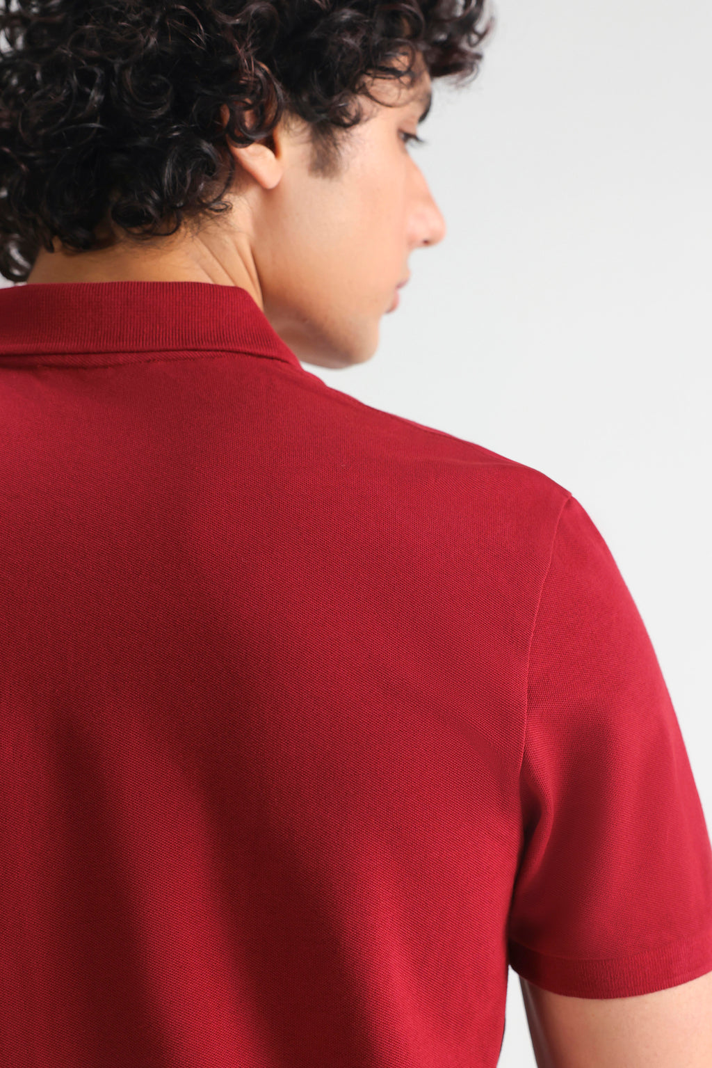 Red (red riding hood) micro-textured cotton pique polo, alternate angle, by SOLA Pakistan.