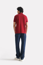 Flat lay of the red (red riding hood) micro-textured cotton pique polo, by SOLA Pakistan.