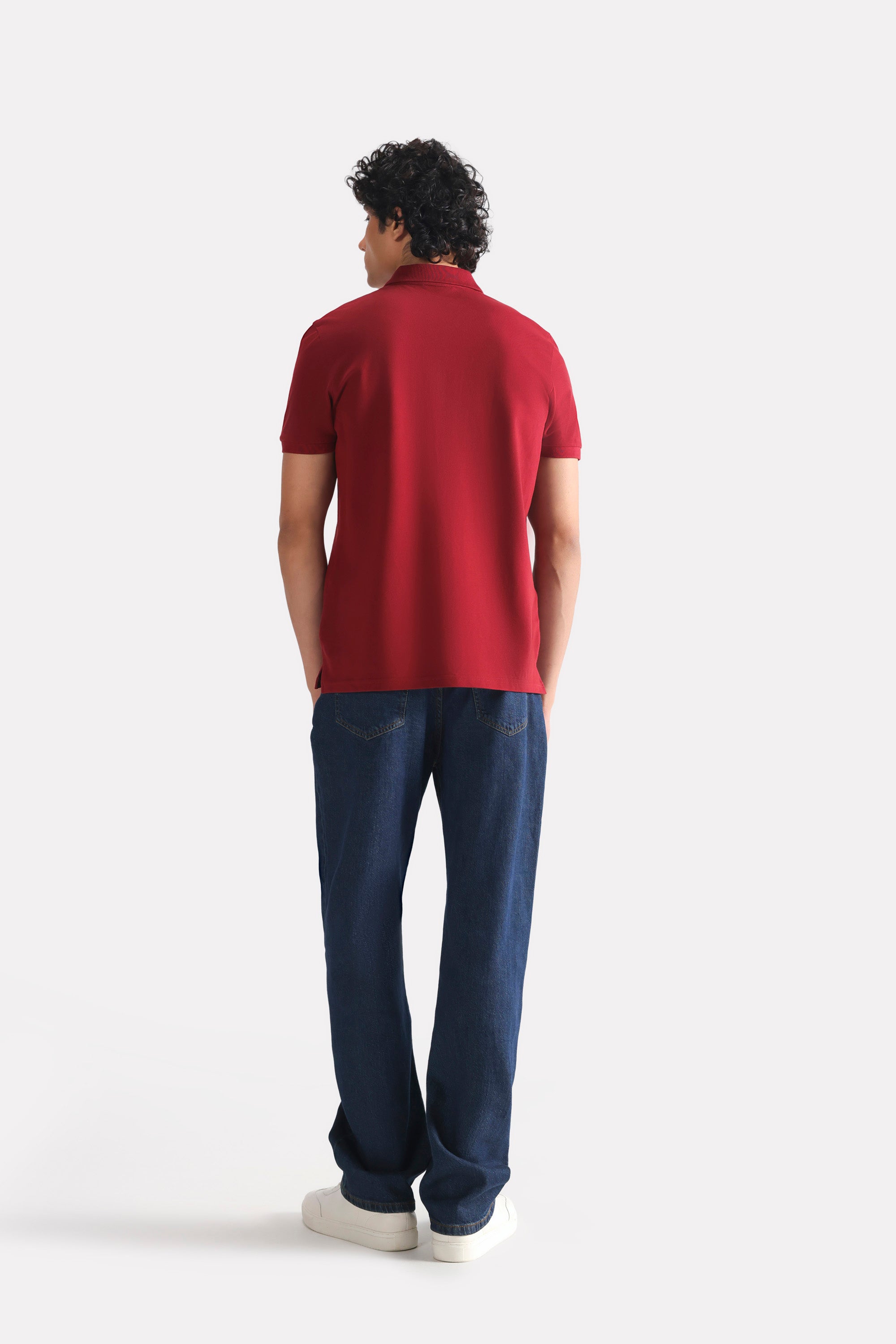 Flat lay of the red (red riding hood) micro-textured cotton pique polo, by SOLA Pakistan.