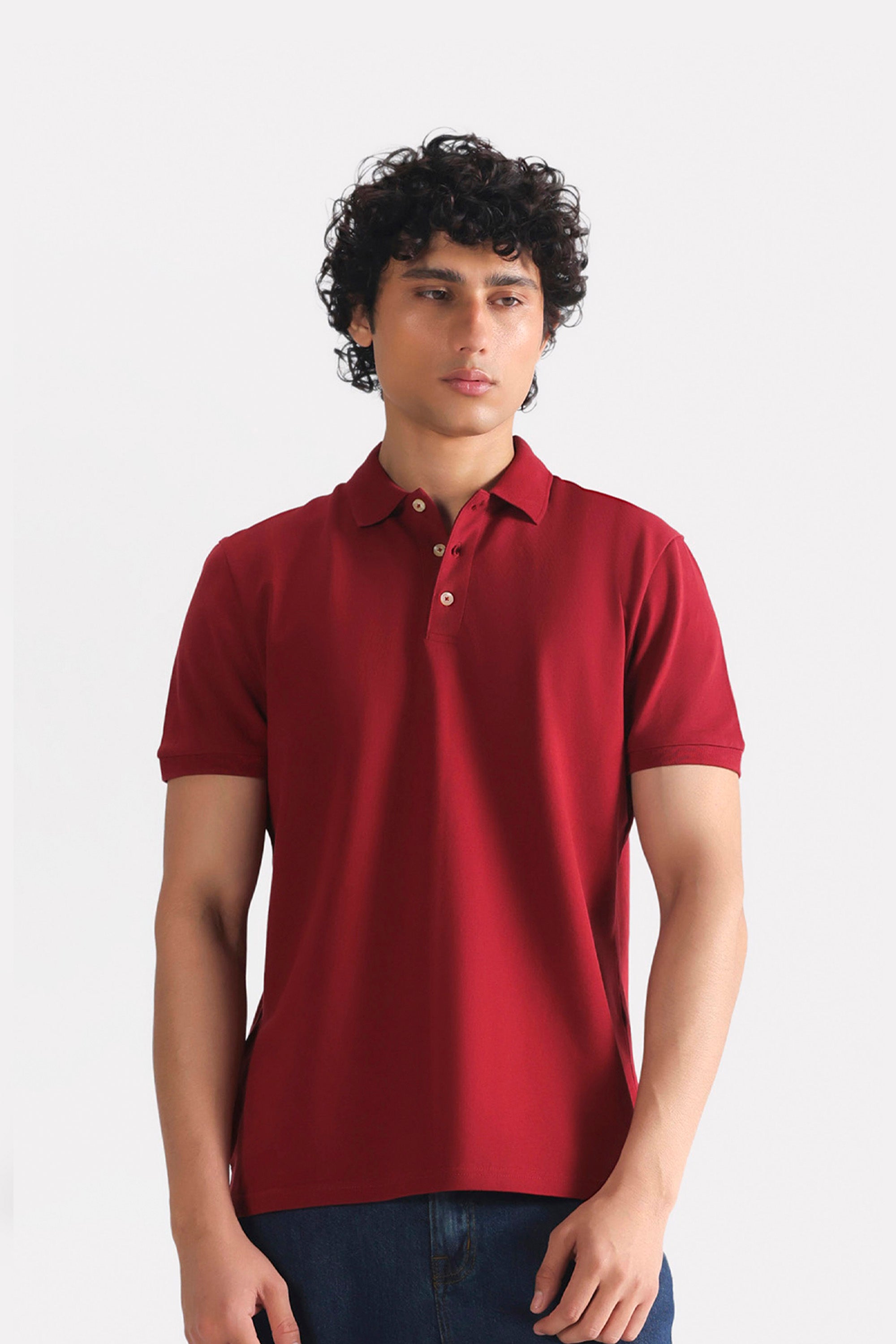 Red (red riding hood) micro-textured cotton pique polo, worn by a model, by SOLA Pakistan.